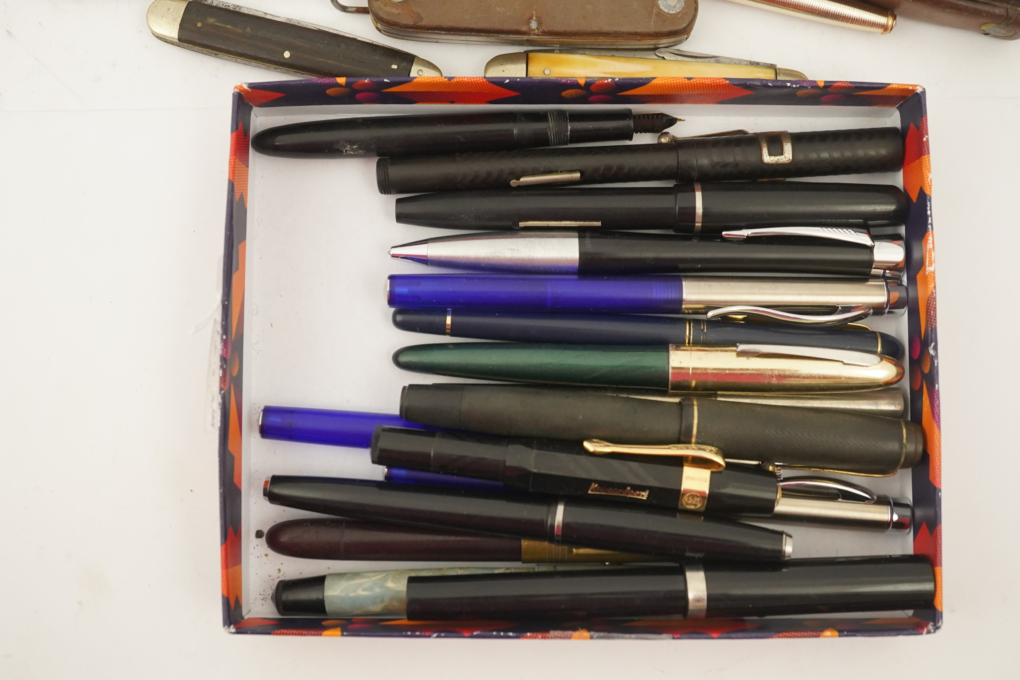 A collection of pens, etc. from 1950's and later and a collection of propelling pencils from 1930's and later, four penknives and a slide rule